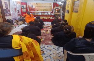 Devotees in meditation during a puja at the centre