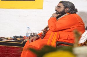 Saffron-robed spiritual guide seated in contemplation