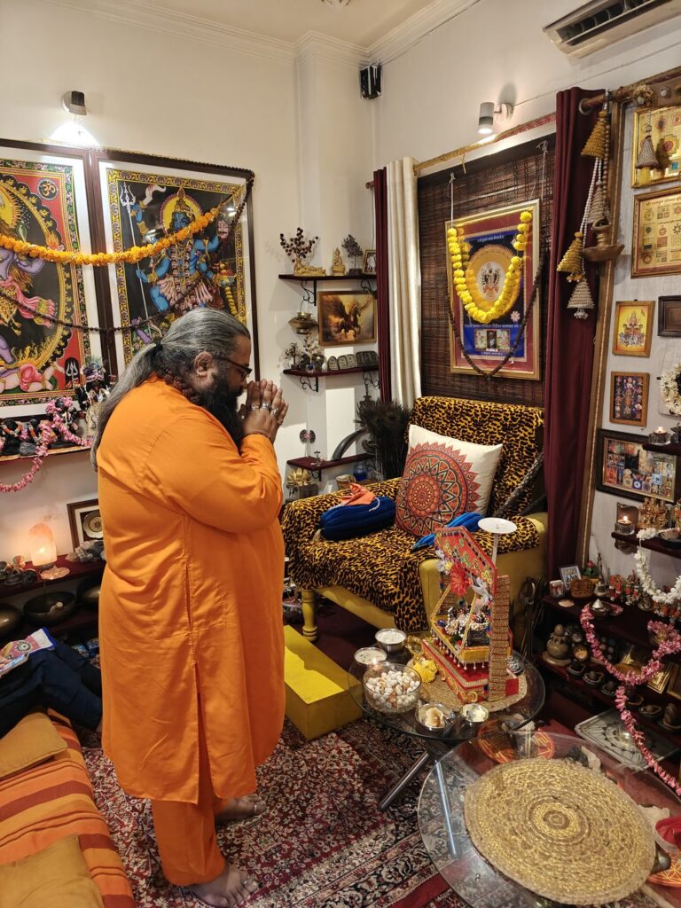 Tantrguru Shree Ganesh Dubey offers prayers with folded hands before the Janmashtami puja at the Agnitra Foundation centre