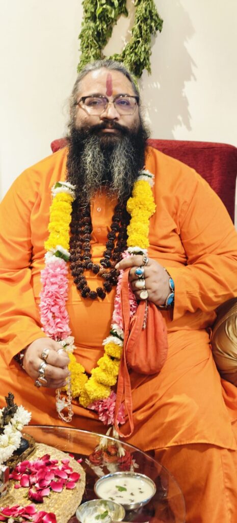 Tantrguru Shree Ganesh Dubey wearing marigold and rose garlands with rudraksha mala on Janmashtami