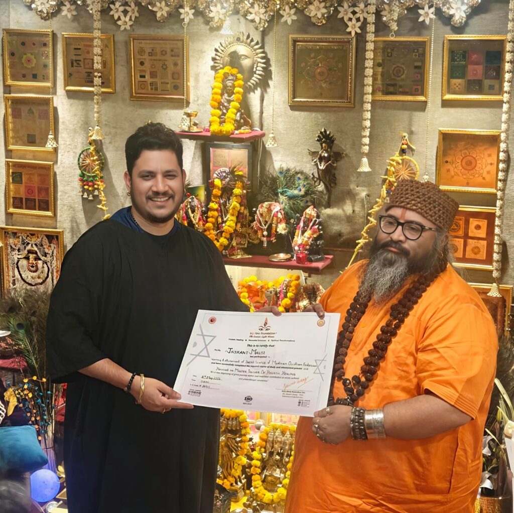 Tantrguru Shree Ganesh Dubey awards a Master Teacher of Holistic Healing certificate to a tantra student at the Agnitra Foundation ceremony in Delhi, May 2026