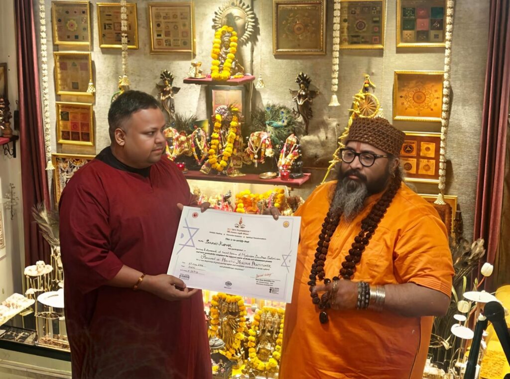Tantrguru Shree Ganesh Dubey awards a Holistic Healing Practitioner certificate to a tantra student at the Agnitra Foundation ceremony in Delhi, May 2026