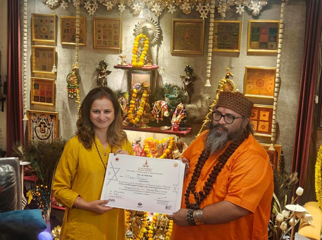 Tantrguru Shree Ganesh Dubey awards a Holistic Healing Practitioner certificate to a tantra student at the Agnitra Foundation ceremony in Delhi, May 2026