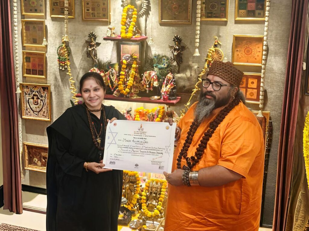 Tantrguru Shree Ganesh Dubey awards a Master Teacher of Holistic Healing certificate to a tantra student at the Agnitra Foundation ceremony in Delhi, May 2026