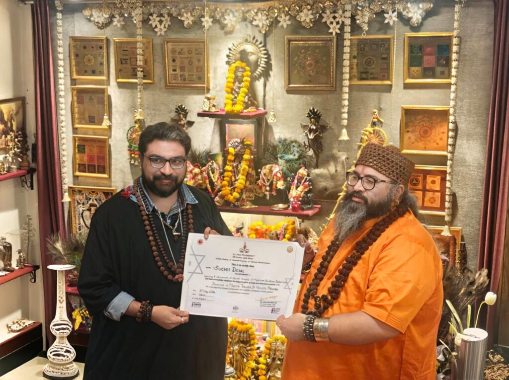 Tantrguru Shree Ganesh Dubey awards a Master Teacher of Holistic Healing certificate to a tantra student at the Agnitra Foundation ceremony in Delhi, May 2026
